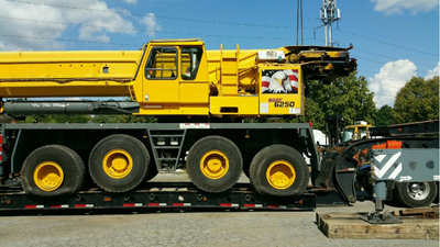 Export Logistics & Shipping, Inc. loads Grove GMK6250 onto flat rack